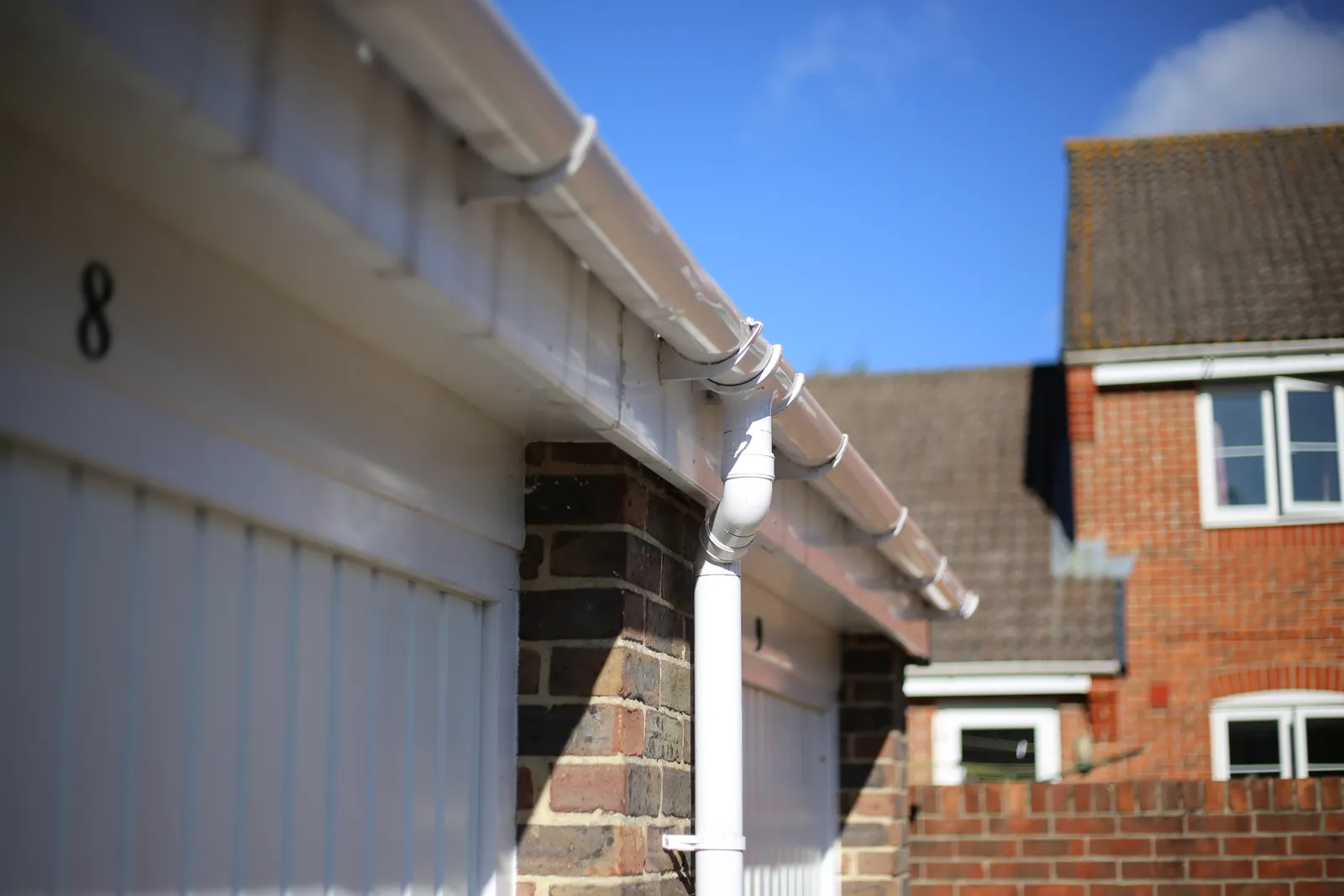 White pvc guttering downpipe garage