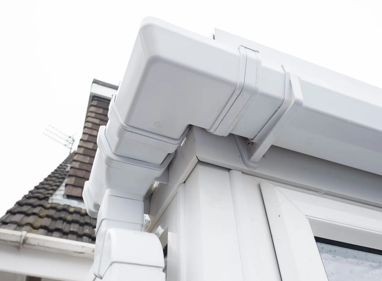 White upvc gutter corner downpipe detail