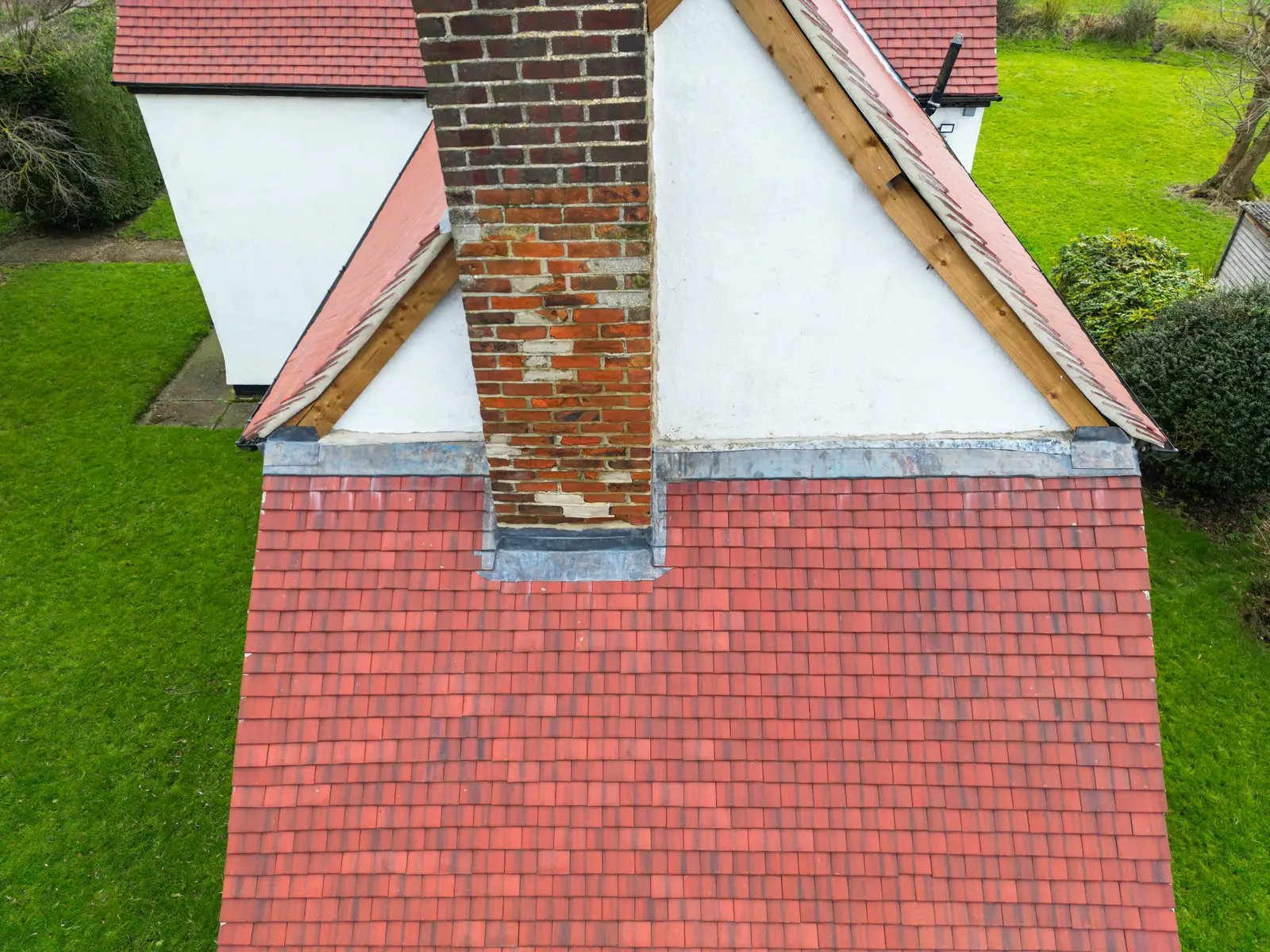 Tiled slate red clay tile roof with chimney